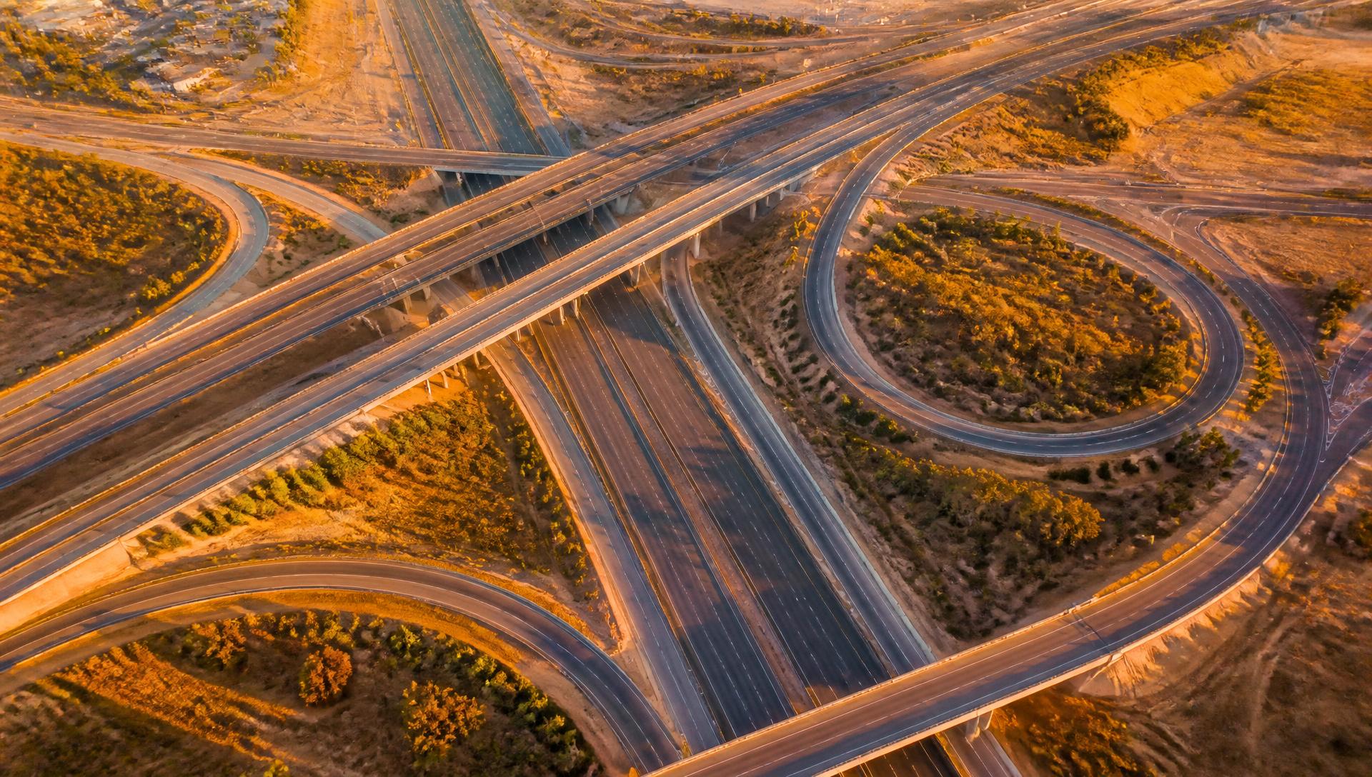 Aerial view of a multi-level highway interchange at golden hour